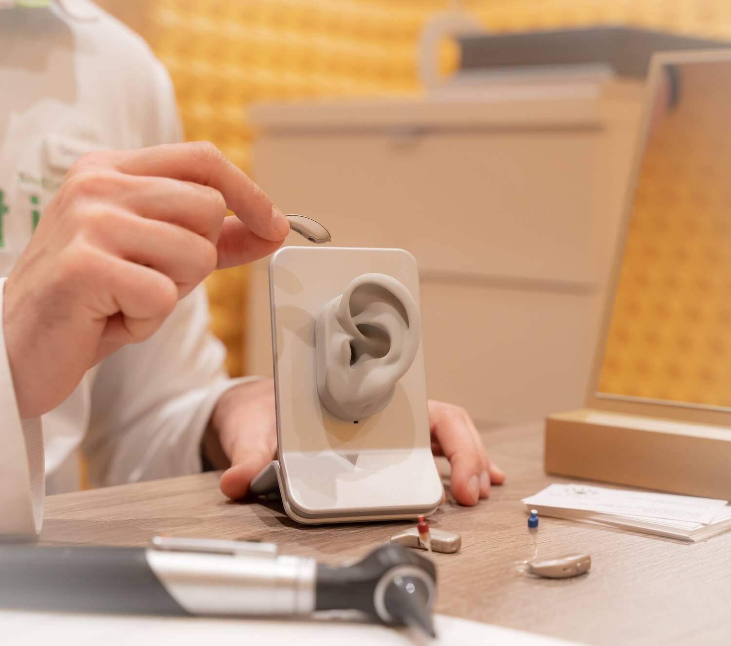 Audiologist showing hearing aids